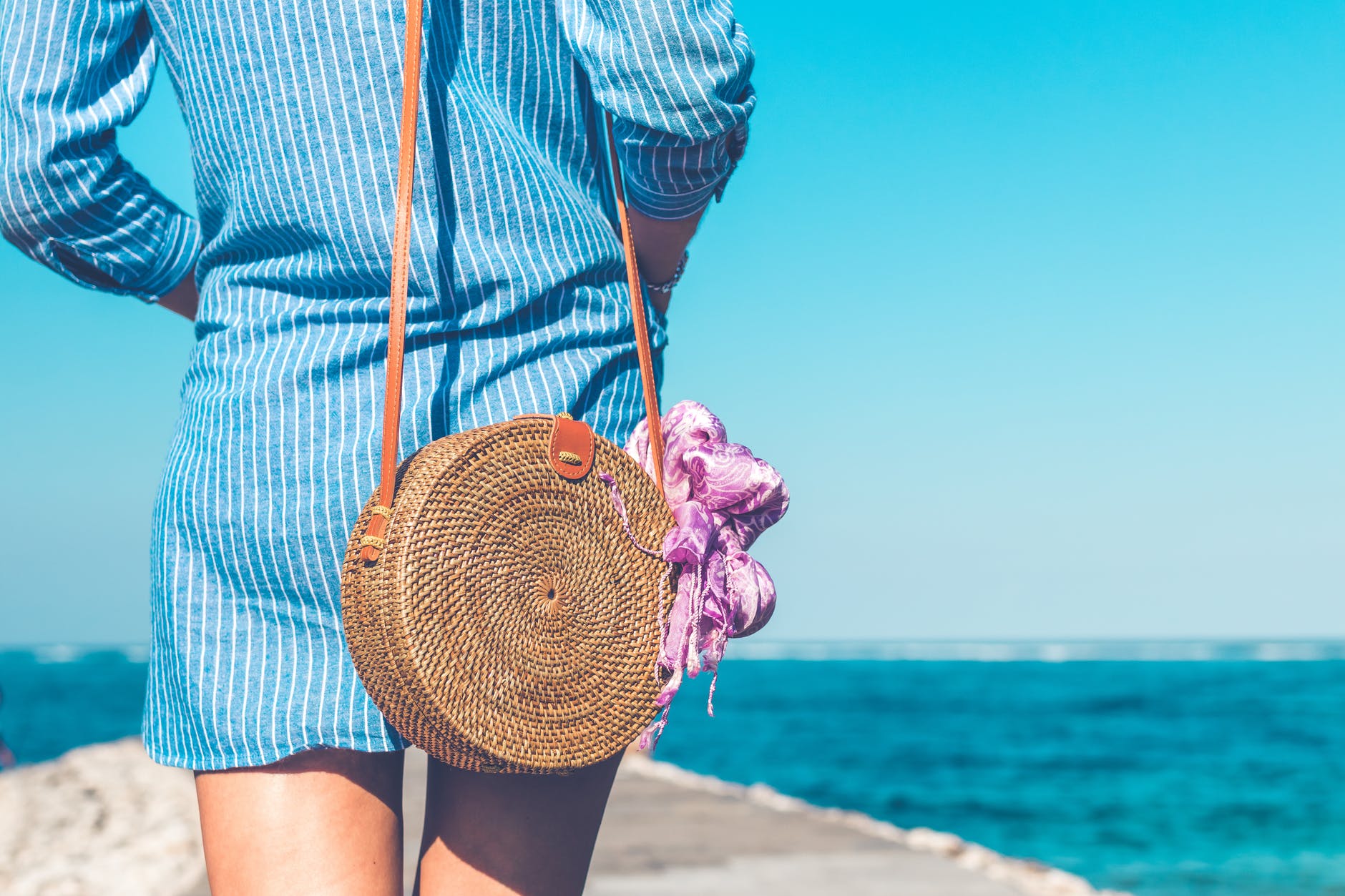 Woman modelling the back of a dress on the beach