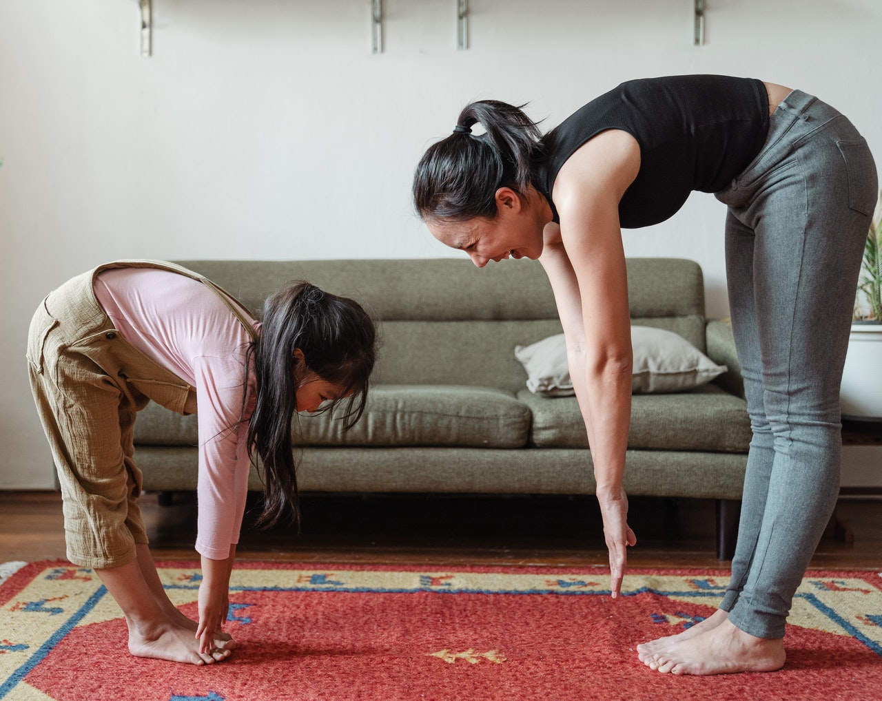 Mum and daughter exercising together Mum and daughter exercising together