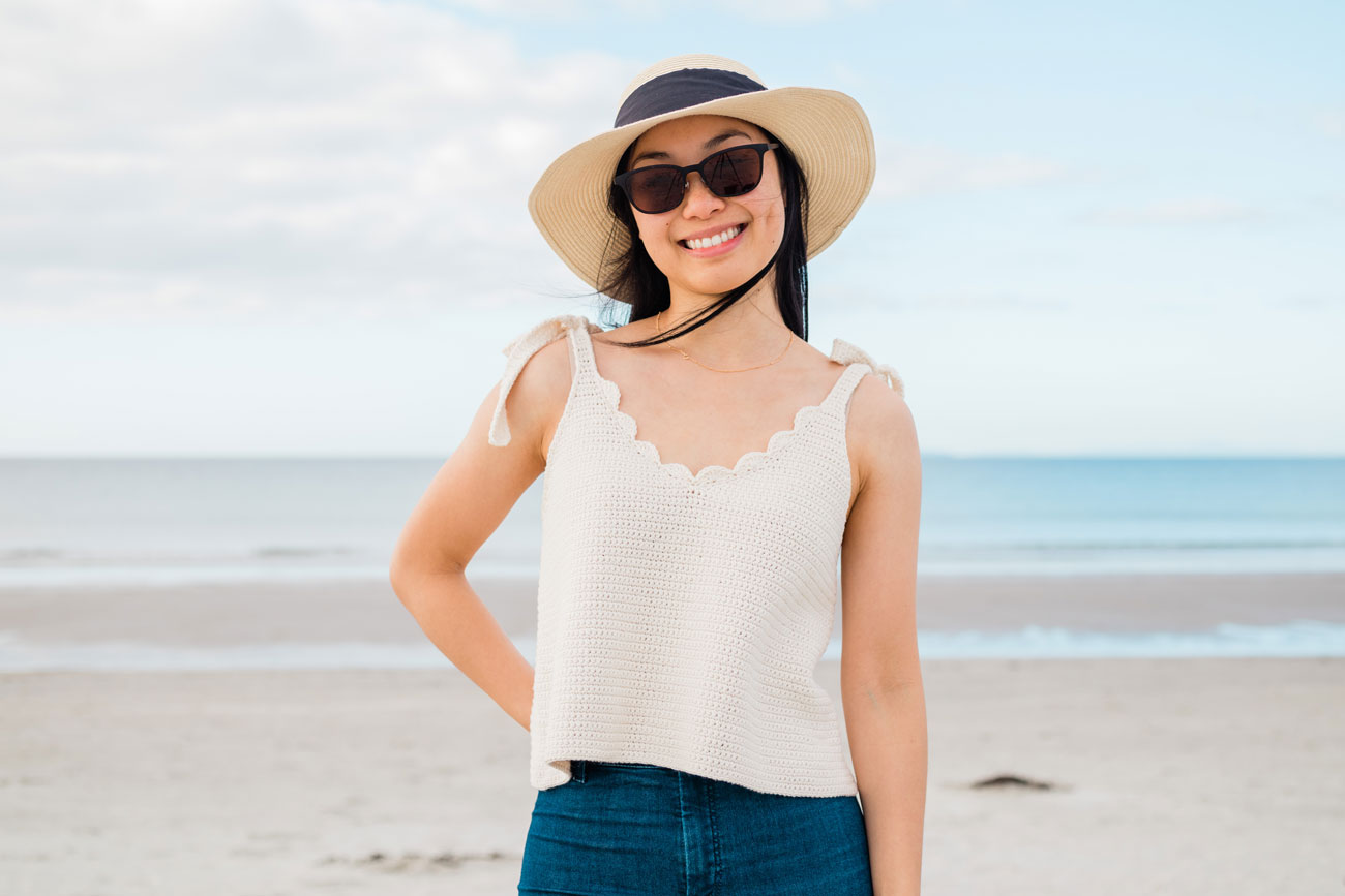 Woman looking summery in a cream v-neck cami and a denim skirt Woman looking summery in a cream v-neck cami and a denim skirt
